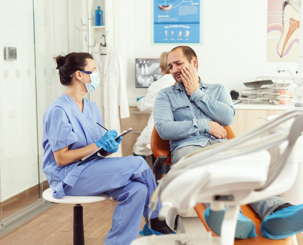 Dentist explaining emergency dental treatment plan to patient after abscess assessment in Sherwood Park
